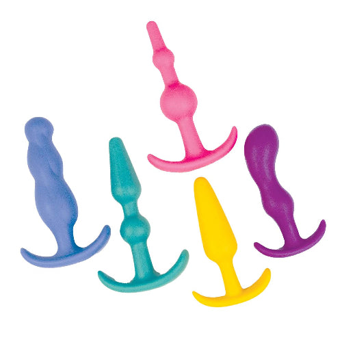 Set of colorful silicone butt plugs on a white background