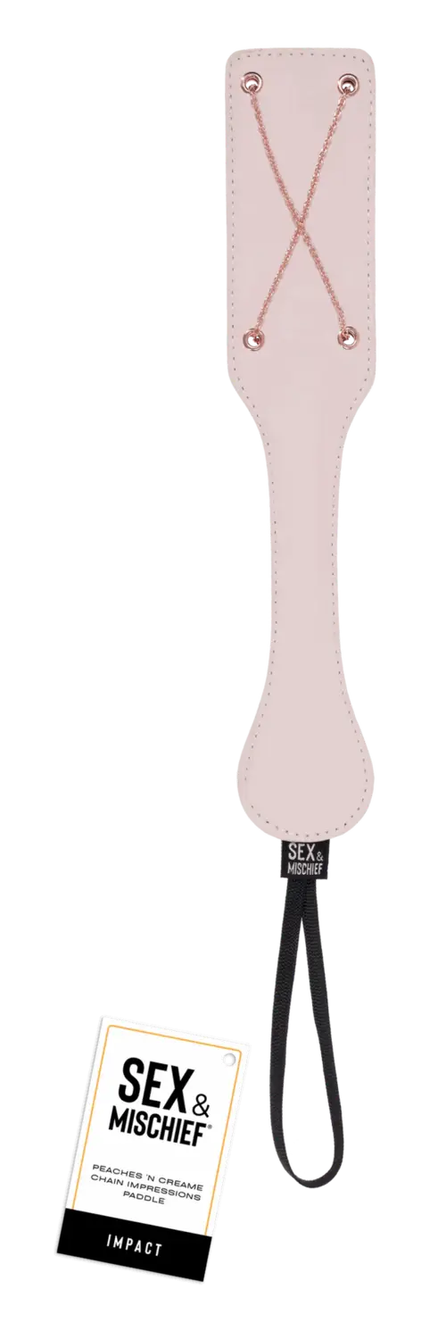 Peaches 'n CreaMe chain paddle - peach color with rose gold criss-crossed chains and tag near the bottom that says Sex & Mischief