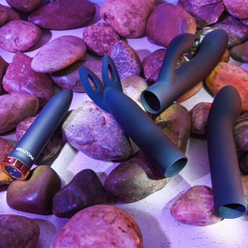 four play sex toy kit with purple rocks in background