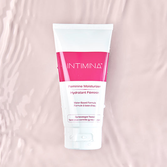 Intimina feminine moisturizer - white and pink bottle against pink water background