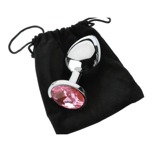 metal butt plug with pink gem base on top of black storage bag
