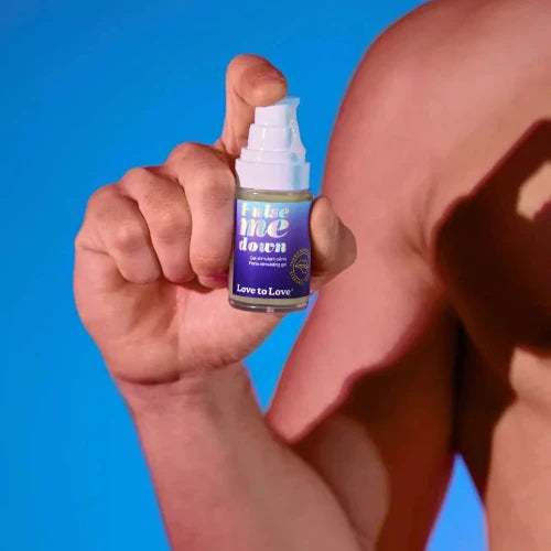 hand holding pulse me down penis stimulating gel bottle - blue background