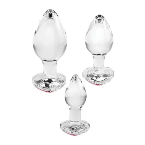 Set of three red gem glass butt plugs against white background