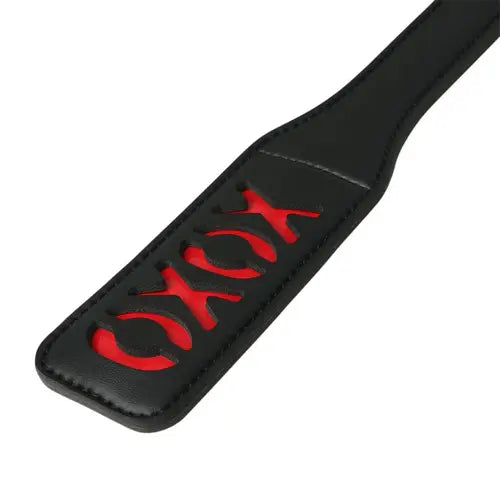 Black paddle with red XOXO design