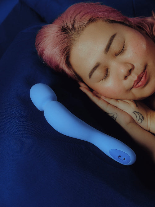 person sleeping peacefully next to com wand vibrator in periwinkle