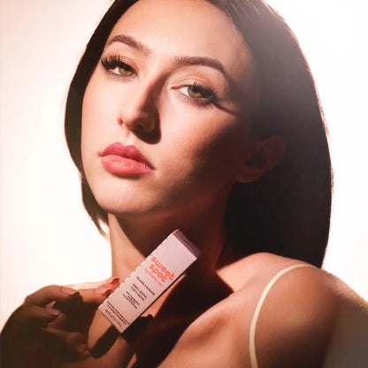 Woman holding a product labeled 'Sweet Spot' against a neutral background