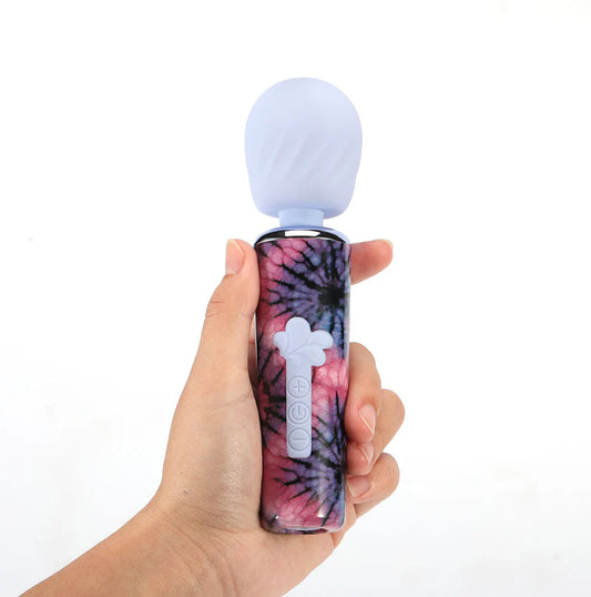 hand holding the JOURNEE mini vibrator - purple tip with tie dye handle