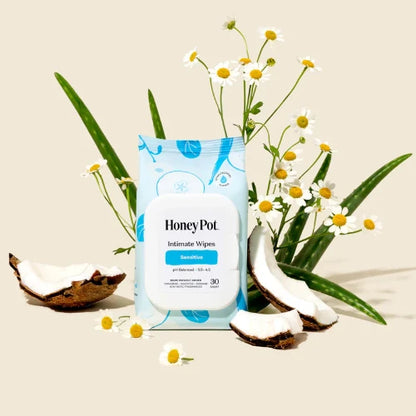 Pack of Honey Pot Intimate Wipes with coconuts and flowers on a beige background