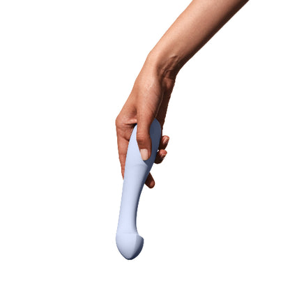 Hand holding Dame Arc vibrator in ice color