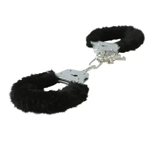 Black furry handcuffs with metal clasps against white background, side view