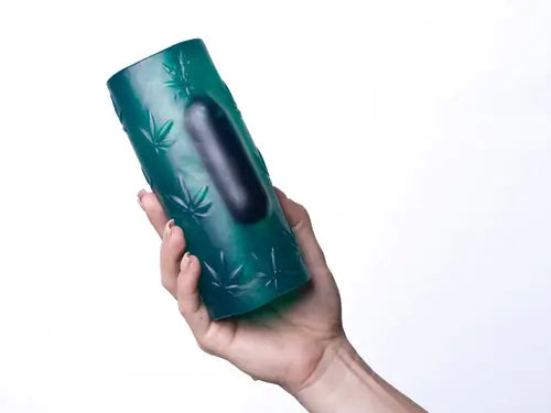 hand holding dark green blaze tunnel with insertable vibrator