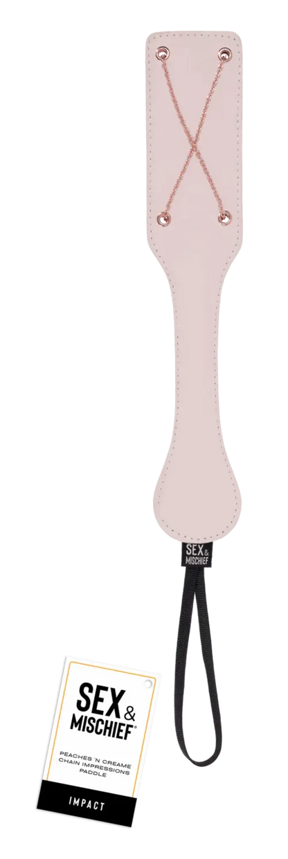 Peaches 'n CreaMe chain paddle - peach color with rose gold criss-crossed chains and tag near the bottom that says Sex & Mischief
