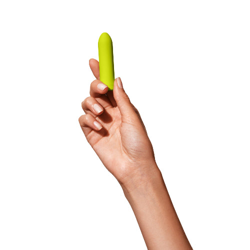 hand holding dame zee vibrator in citrus