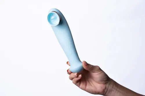 Hand holding blue DESTINY clitoral suction vibrator