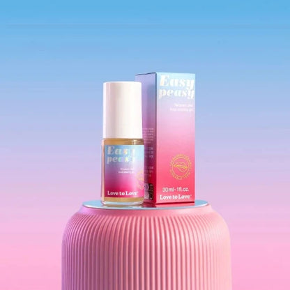 easy peasy bottle and package on pink table with blue and pink pastel background