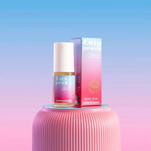 easy peasy bottle and package on pink table with blue and pink pastel background