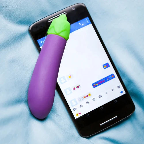 eggplant vibrator next to phone