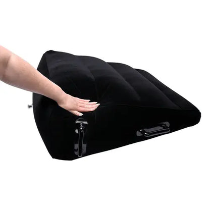 Hand pressing down on Inflatable Positioner Plus Black Wedge-shaped Sex Pillow 
