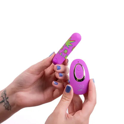 Hands holding Jessi purple remote control bullet vibrator against white background