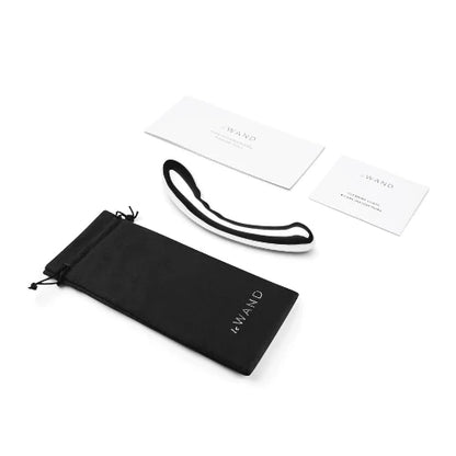 le wand arch massager next to black storage bag and two instruction cards