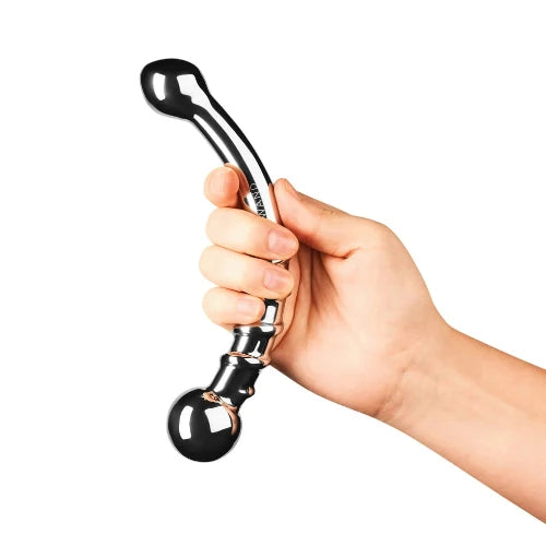 hand holding double ended le bow massager against white background