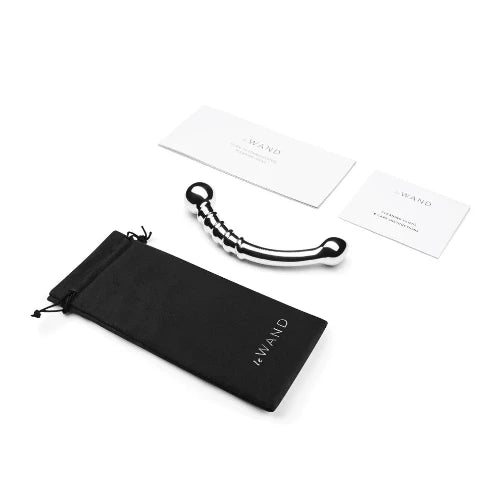 stainless steel bow massager next to soft storage bag and two white cards