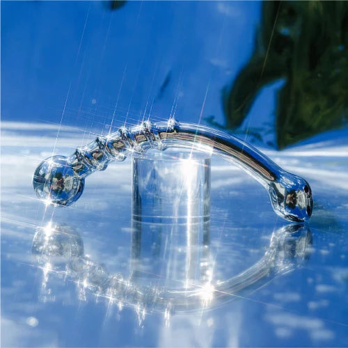 le wand bow massager - metal dildo with blue background