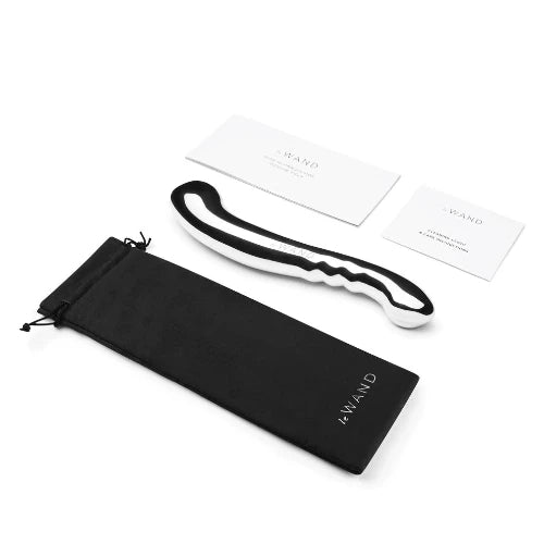 le wand stainless steel contour dildo next to black soft storage bag and instruction cards