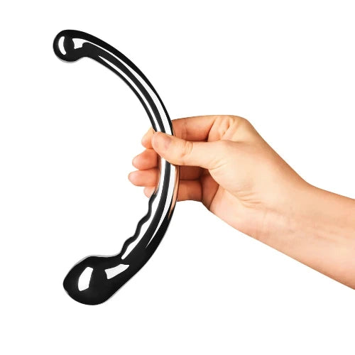 hand holding le wand hoop stainless steel massager against white background