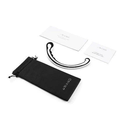 le wand hoop stainless steel massager next to black storage bag and instruction cards
