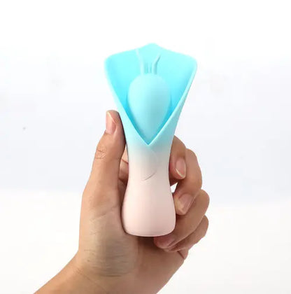 Hand holding MINA blue fluttering vibrator against white background
