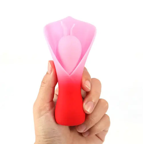 Hand holding MINA red fluttering vibrator against white background