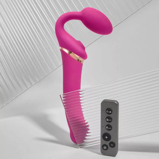 fuchsia strapless strap on against white background next to remote control