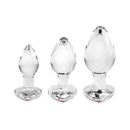 red gem set of three glass butt plugs in varying sizes against white background