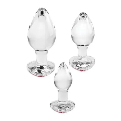 Set of three red gem glass butt plugs against white background