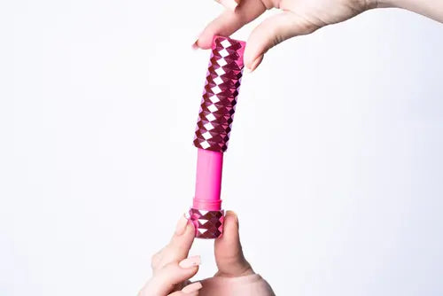 Hands opening Roxie pink lipstick bullet vibrator with case