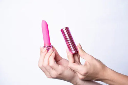 Hands holding Roxie pink lipstick bullet vibrator with case