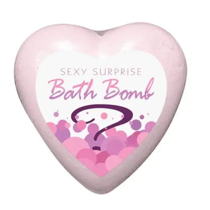 pink heart-shaped bath bomb with label that reads "sexy surprise bath bomb" with a purple question mark