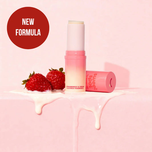 fragrance stick next to strawberries and cream - pink background