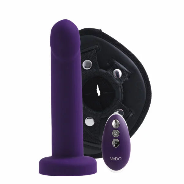 purple dildo in front of black harness with purple remote